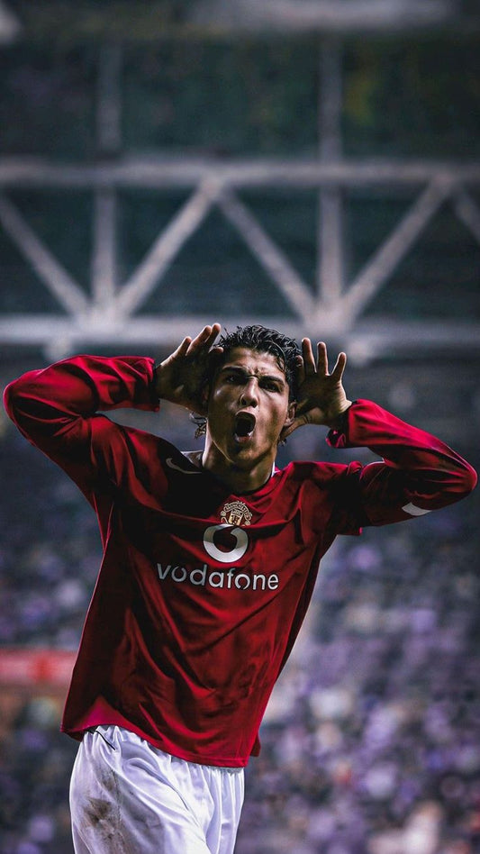 Person wearing a red sports jersey with a logo, standing on a field.