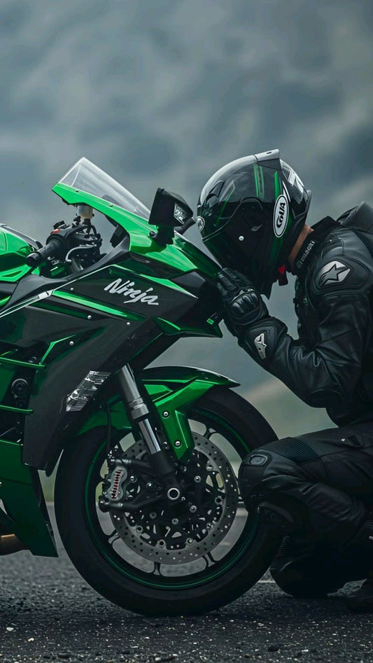 Person wearing a helmet and black jacket next to a green motorcycle with 'Ninja' branding on a cloudy day.