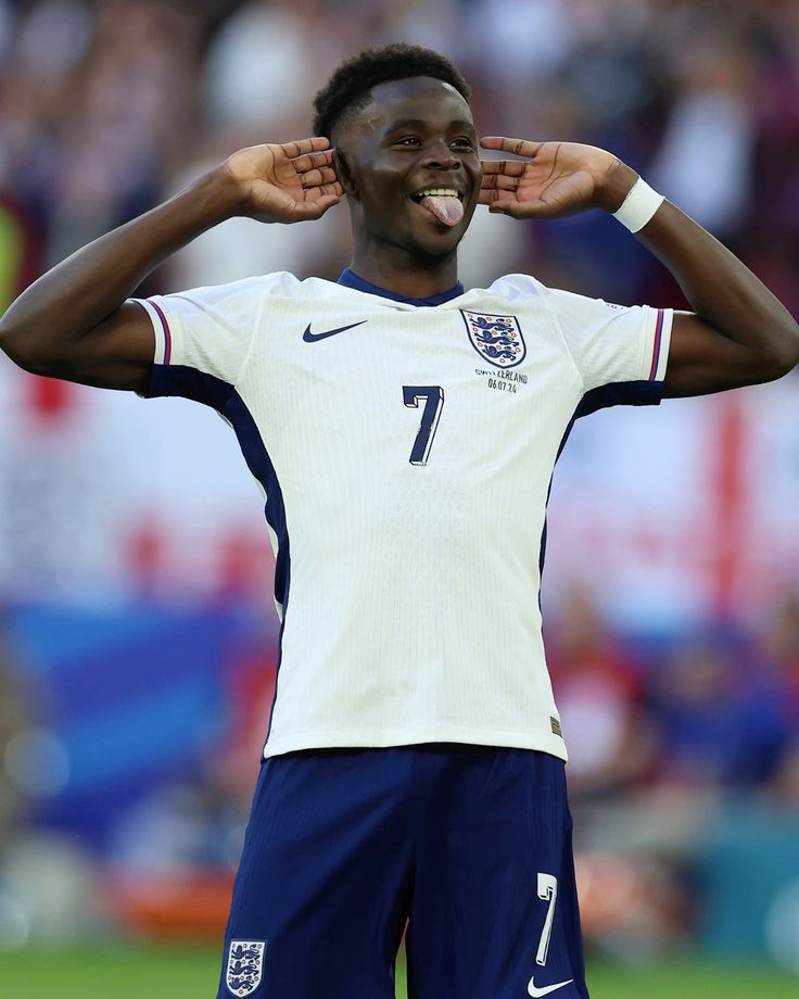 Soccer player wearing an England jersey with the number 7 on a blurred stadium background