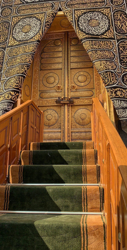 Decorative staircase with intricate wooden paneling and carpeting.