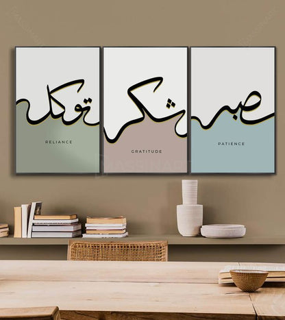 Three framed artworks with Arabic calligraphy and English translations on a wall above a shelf.