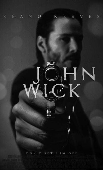 Black and white image of a person holding a gun with 'John Wick' text overlay.
