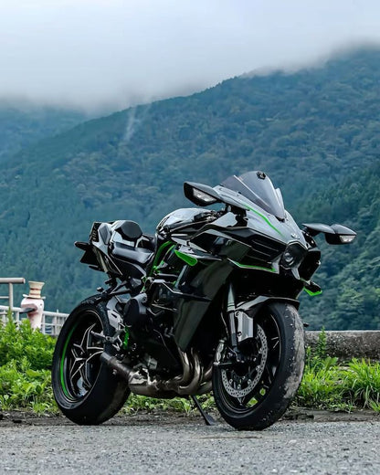 Motorcycle parked on a road with mountains in the background