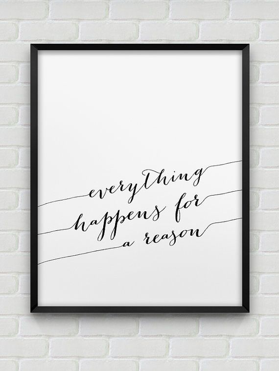 Framed print with 'everything happens for a reason' text on a white brick wall.