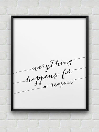 Framed print with 'everything happens for a reason' text on a white brick wall.