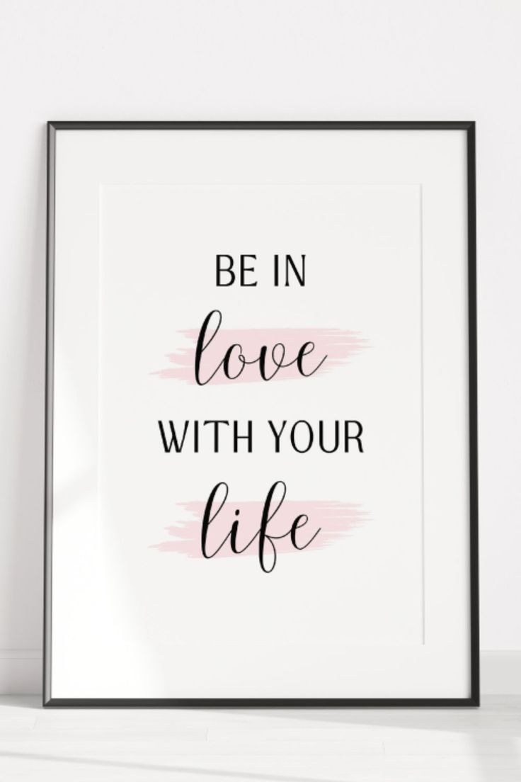 Framed poster with motivational quote 'Be in love with your life' on a white background