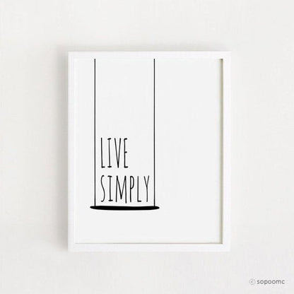 Framed poster with 'Live Simply' text on a white background
