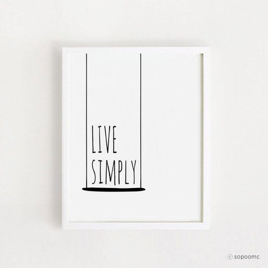 Framed poster with 'Live Simply' text on a white background